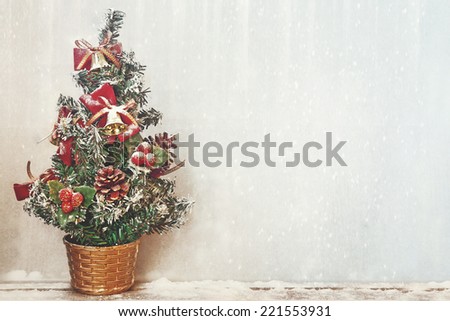 small christmas tree with snowfall background