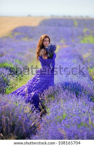 Series. Portrait of beautiful romantic woman in fairy field of lavender with bouquet