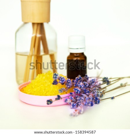 Essential oil and herbal lavender salt with lavender flowers. Aromatherapy. On a white background.