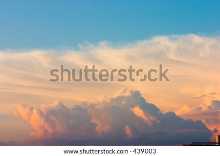 Blue sky with white, yellow and rose clouds