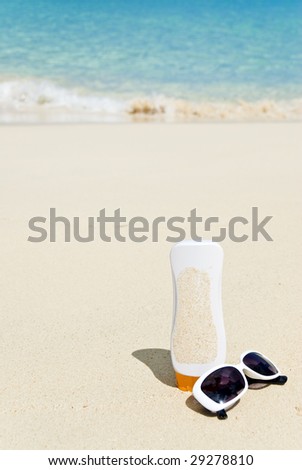 Sun Glasses and sunscreen on a Caribbean Beach
