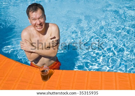 Man Feeling Cold in a Swimming Pool