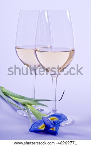 Two Glasses of White Wine and a Iris Flower