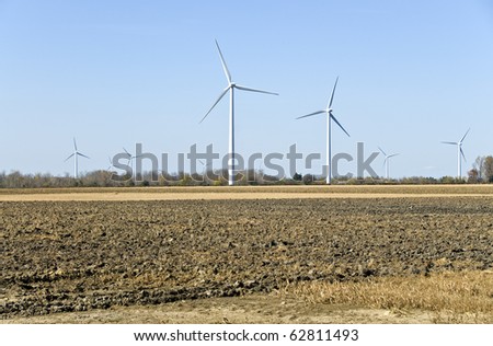 Power Generating Windmills Against the  Blue Sky in a Field