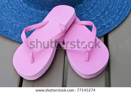 Pink Flip Flops and Blue Straw Hat on the Deck
