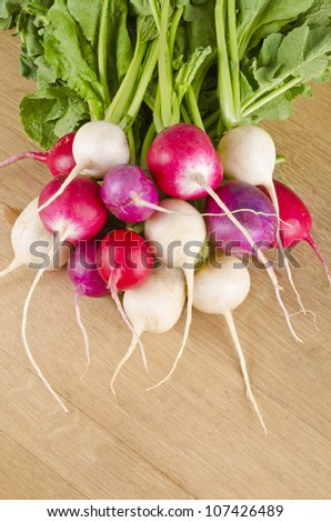 Red, Purple and White Radishes on Wood Surface