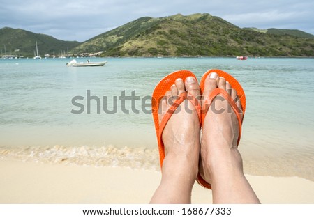 Woman Wearing Orange Flip Flop on the Beach