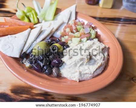 Platter Filled with Hummus, Olives, Salsa and Pita Bread