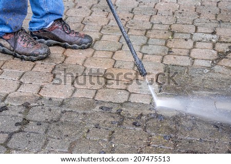 Man Washing Patio with a Power Washer