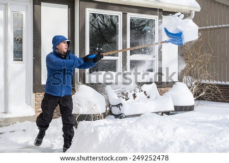 Man Removing Snow with a Shovel