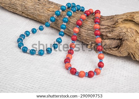 Colorful Wood Beads Necklace Over a Tree Branch Shot in Studio