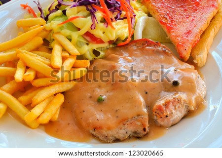 grilled steak, french fries, toast and salad