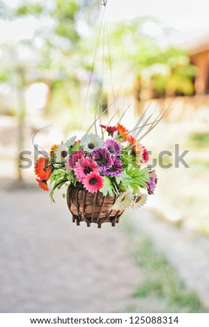 Hanging basket of artificial flowers