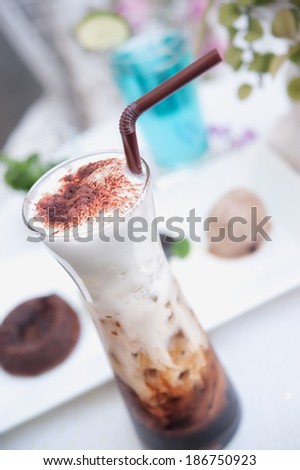 delicious iced coffee with foam  on the table