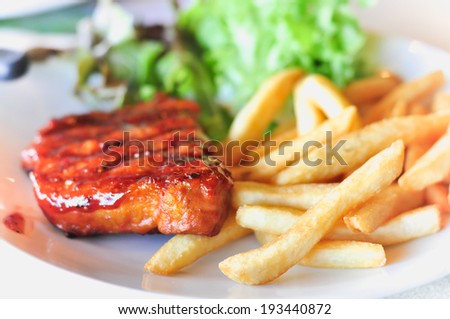 Pork loin steak in a dish Serve with French fries