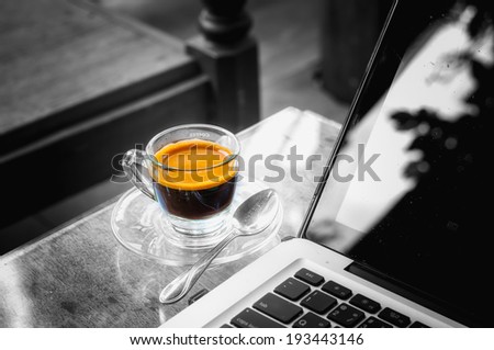 laptop and hot cup of coffee on wood table, business concept