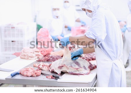 butcher that cuts fresh pork in meat industry
