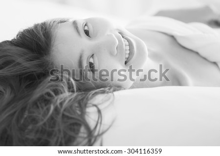 smile asia Beautiful young woman in white bathrobe in bedroom at home, black and white