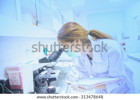 microscope, examining samples and liquid. Medical research