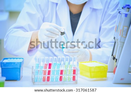 Scientist holds and examine samples in lab room
