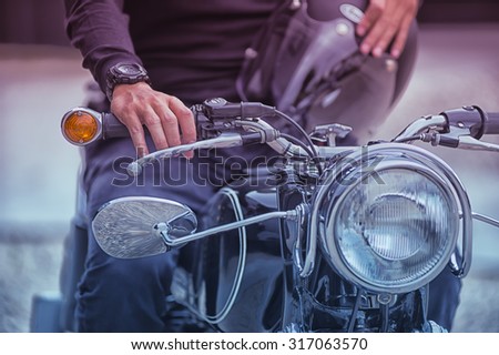 the Biker man sitting on his motorcycle, vintage effect