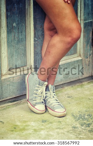 asia women in shoe standing relax against  wood wall, vintage effect