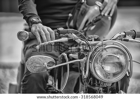 Biker man sitting on his motorcycle, black and white style