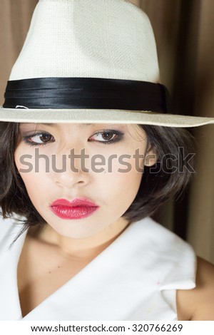 head shot of asia woman with hat in room, beauty concept