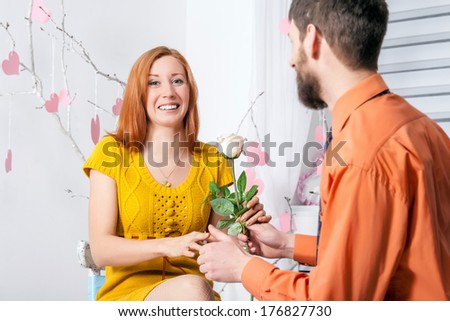 Man giving a rose to girl on Valentine`s day