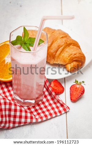 Healthy breakfast with homemade strawberry yogurt, croissant and juicy orange