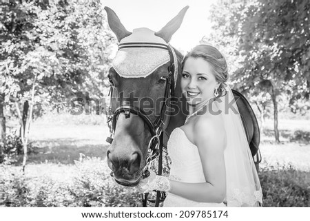 Vintage portrait of beautiful bride holding reins of horse