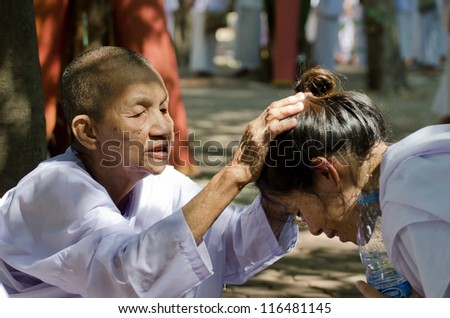 NONTHABURI THAILAND-APRIL 13:people celebrate Songkran (new year / water festival: 13 April) by pouring water for nun and asking for blessings on April 13, 2012 in Nonthaburi,Thailand.