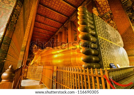 BANGKOK, THAILAND - MAY 24:   Details of the Reclining Buddha statue at the Wat Pho temple  on May 24, 2012  in Wat Pho temple, Bangkok,Thailand.  The reclining Buddha  is 15m high and 43m long.