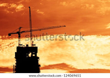 Industrial construction cranes and building   at sunrise.