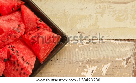Fresh watermelon slices on plate on wooden table with text area