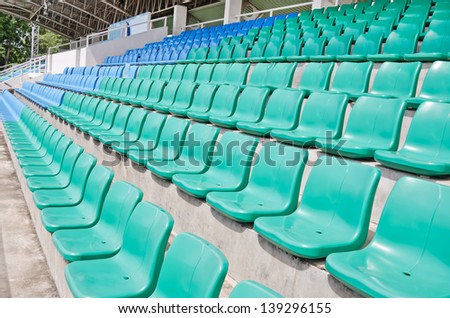 Rows of empty plastic  seats at  football stadium