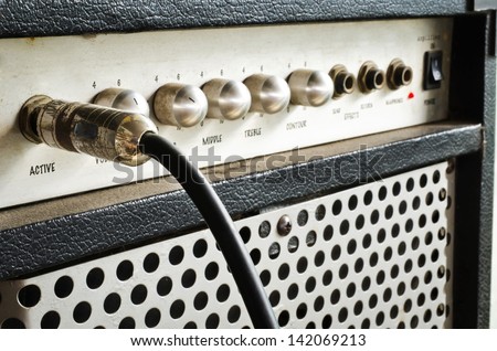 Close-up of guitar amplifier with jack cable