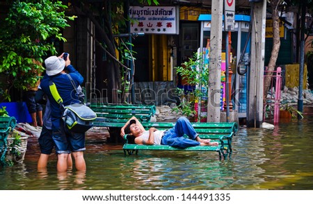 BANGKOK, THAILAND - OCT 31: Flood victim becomes homeless, sleep on bench at Bangkok\'s Chinatown on October 31, 2011 in Bangkok, Thailand