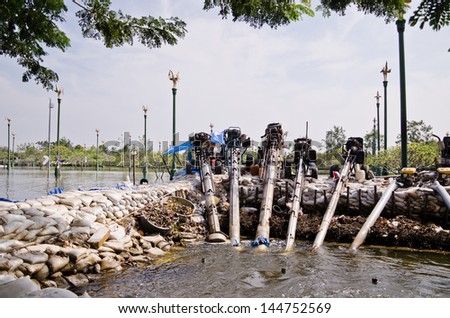 NAKHON PATHOM, THAILAND - NOV 15: Flood water being pumped  by water pumps during the worst flooding crisis  on November  15, 2011 in Nakhon Pathom, Thailand