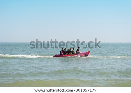 2015 in Petchaburi, PHETCHABURI, THAILAND - JANUARY 3: Tourists enjoying ride Banana Boat adventure at Cha - am on January 3, Thailand. Cha - am beach is the famous seaside resort in Thailand.