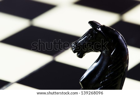 Horse( chess piece) with a chess table in background