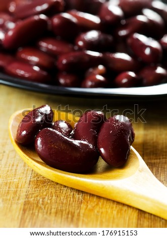 Canned red bean on a wooden spoon,close up image.
