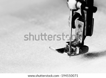 Part of an old sewing machine.Detail on needle.Black and white picture.