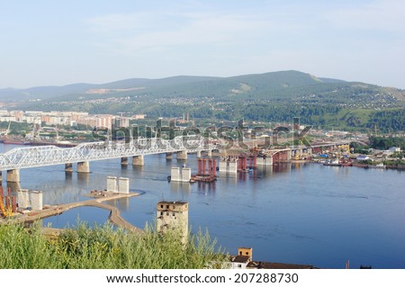 City of Krasnoyarsk (Siberia, Russia). The 4-th Road Bridge building site across the Yenisei river. Industrial cityscape. Summer day, July 22, 2014.