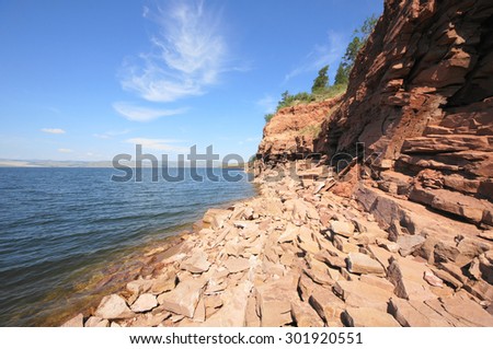 River Yenisei  rocky shore. Krasnoyarsk reservoir near village Anash (Novoselovo area, Krasnoyarski krai, Siberia, Russia). Sunny summer day, July 25, 2015.
