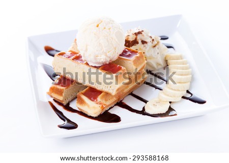 Plate of belgian waffles with ice cream and whipped cream, Strawberry sauce and bananas on white background