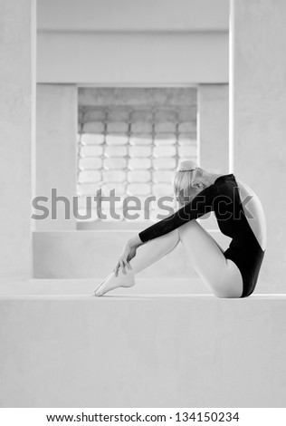 Ballerina woman performer sitting and relaxing.
