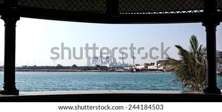 Sheikh Zayed mosque viewed through window from other side of the sea.