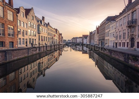 Row of house on both side of canal passing through beautiful city of Bruges, Belgium.