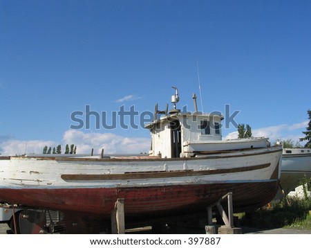 old tug boat on cradle in dry dock